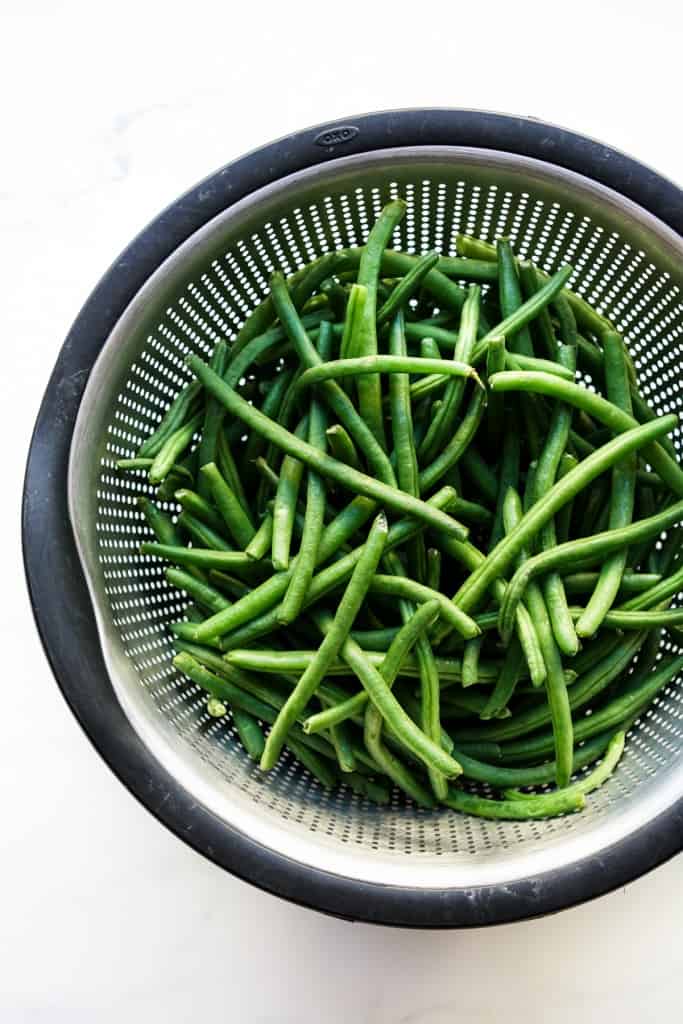 fresh green beans in a colander