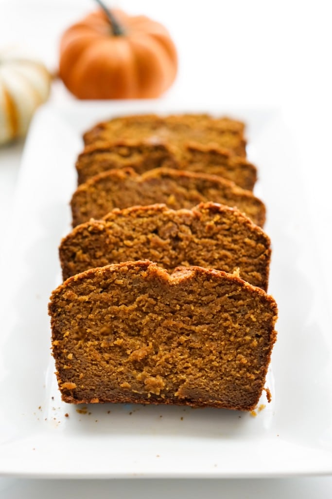 Slices of pumpkin banana bread lined up on a plate