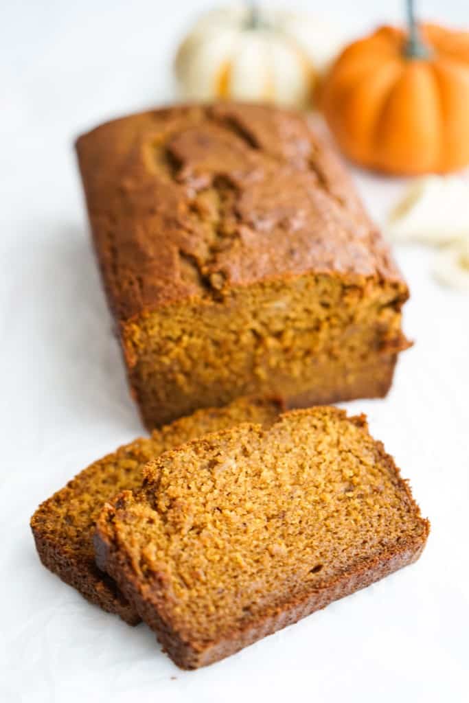 Two slices of pumpkin banana bread sliced off from a loaf