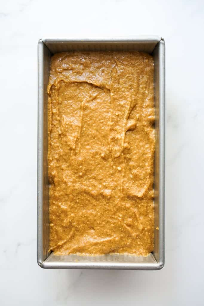 unbaked pumpkin banana bread batter in a rectangular loaf pan