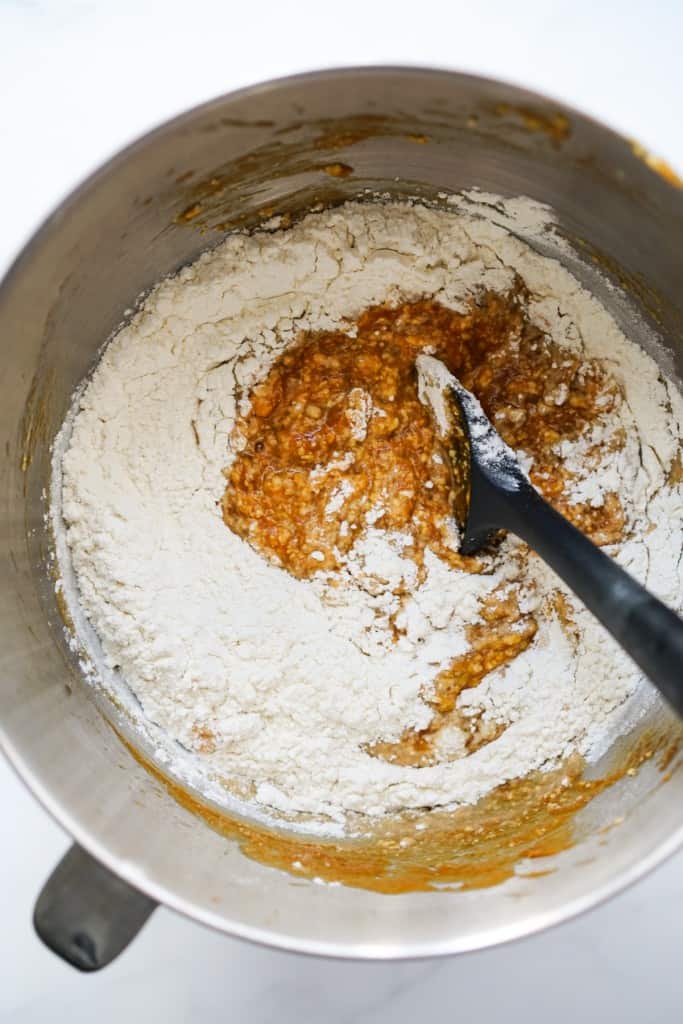 Combining dry ingredient with wet ingredient in a large mixing bowl