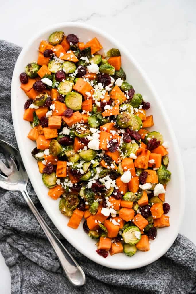 Top down view of a plate of oven baked sweet potatoes and brussels sprouts