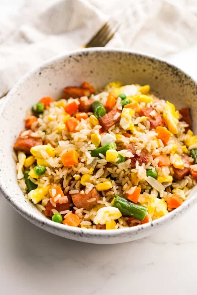A bowl of Spam fried rice with mixed veggies and scarmbled eggs