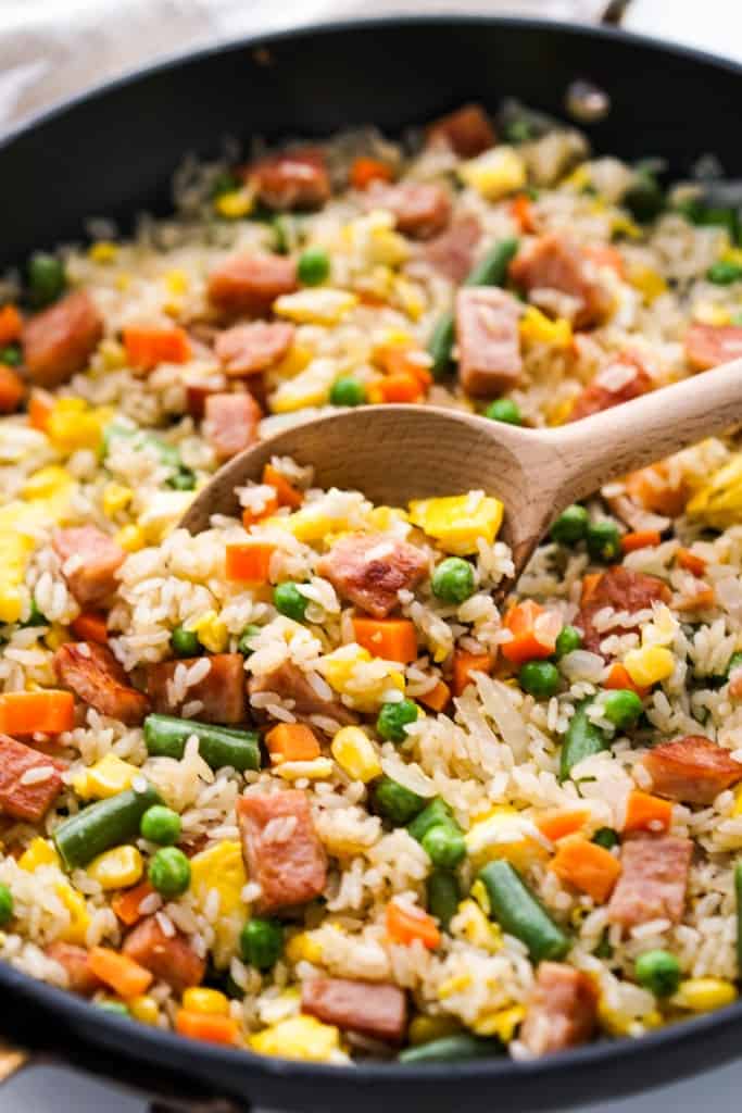 Scooping up some spam fried rice from the skillet