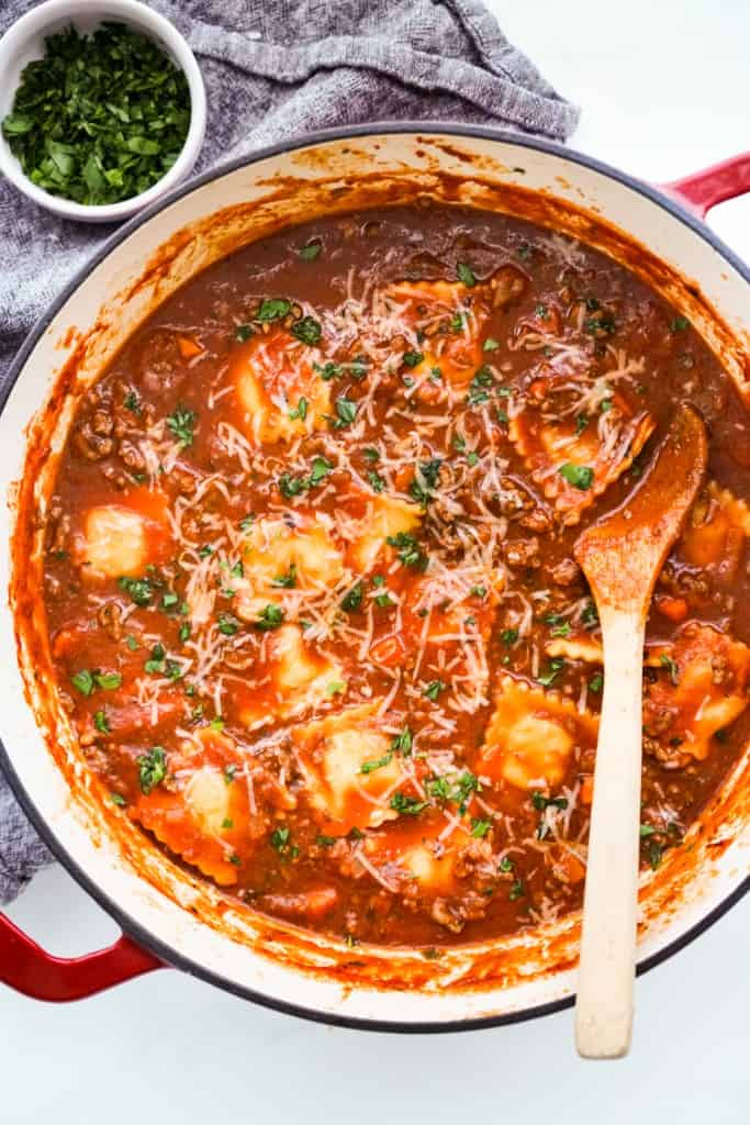 A large Dutch oven filled with thick ravioli soup