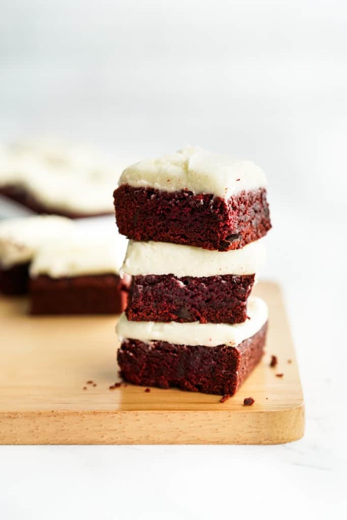 Three red velvet brownies stacked on top of each other 