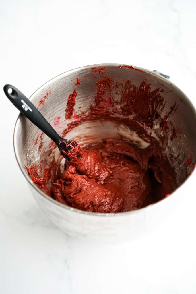 Red velvet brownie batter in a large stainless steel mixing bowl