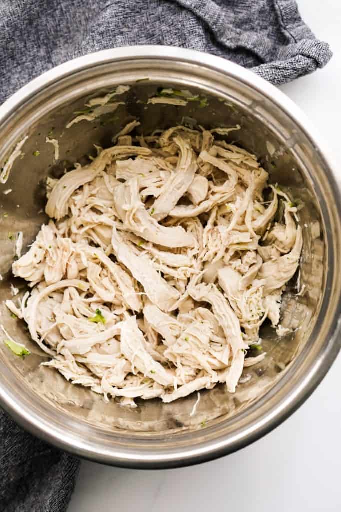 Shredded chicken in a mixing bowl