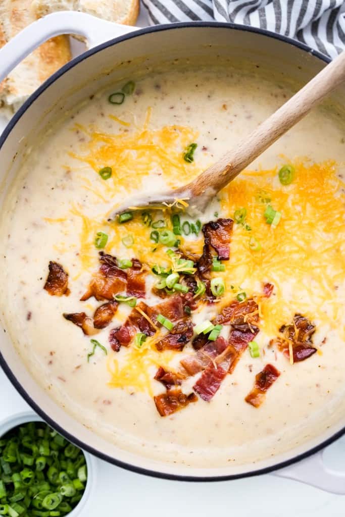 Top down view of a big pot of potato soup cooked with mashed potatoes