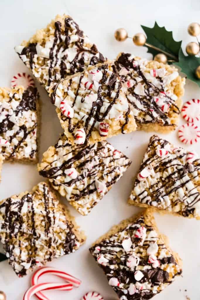 Peppermint Rice krispie treats topped with chocolate drizzle, chocolate drizzle, and crushed peppermint patties