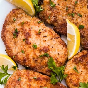 Closeup look of pork chops coated in crispy parmesan breading