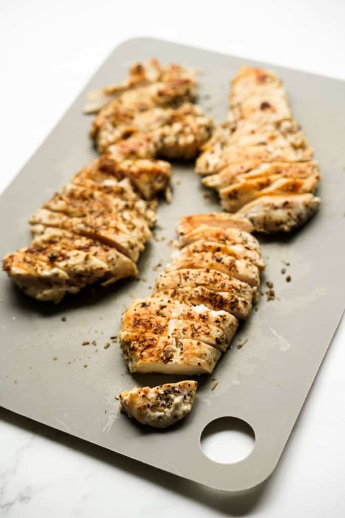 Sliced chicken breast on cutting board