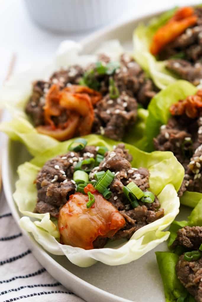 Focused view of bibb lettuce loaded with Korean bbq beef and kimchi