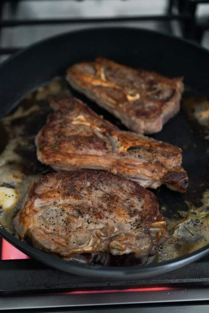 Searing lamb chops in skillet in butter