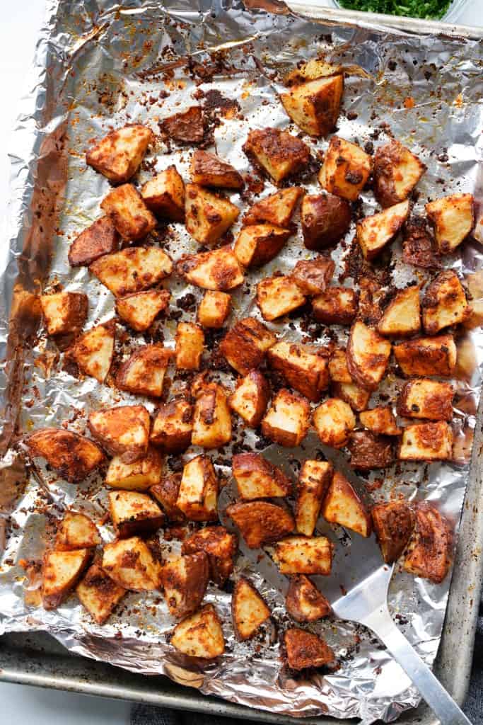 Roasted red potatoes on a sheet pan lined with aluminum foil