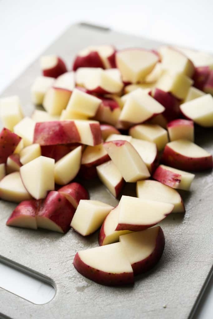 Diced red potatoes on a cutting board