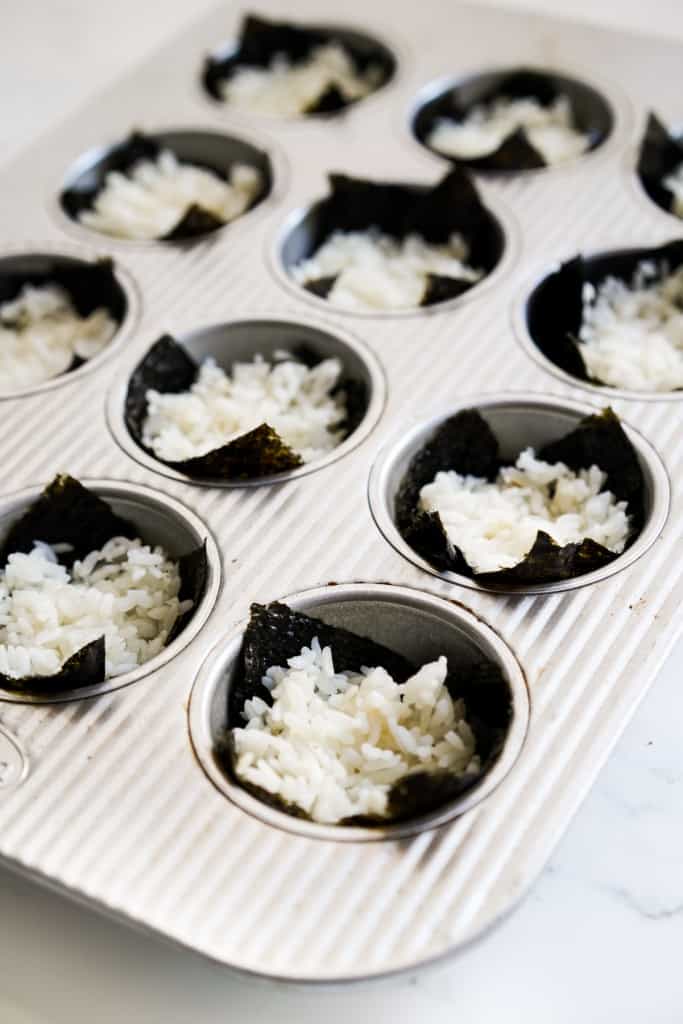 Nori in muffin cups topped with sushi rice