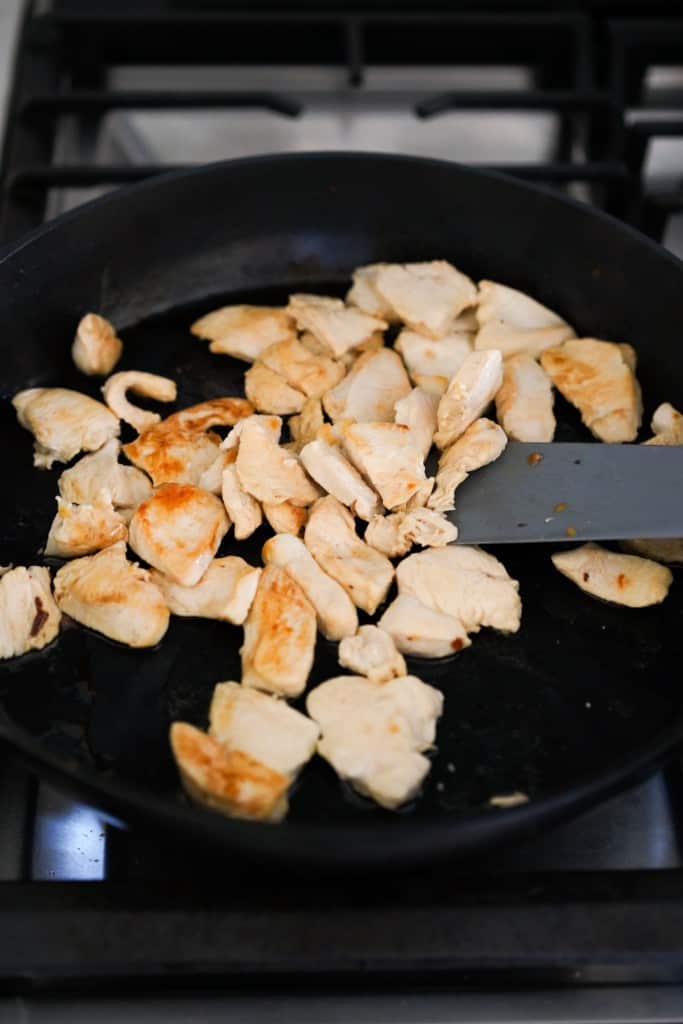 Searing chicken cubes in skillet