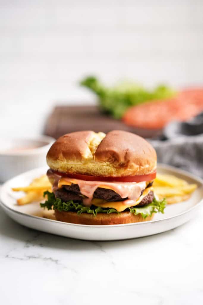 A double patty smash burger on brioche bun served with fries