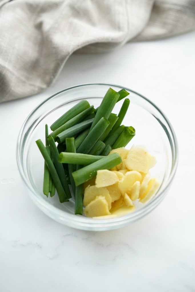 a bowl of sliced ginger and scallions