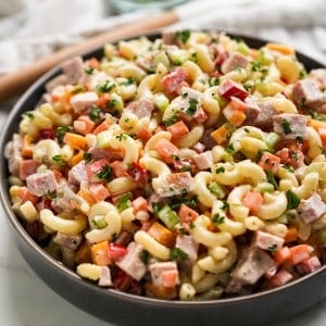 A large colorful bowl of macaroni ham salad