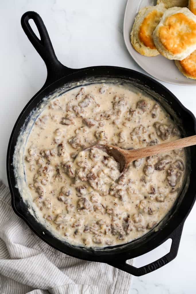 Top down view of creamy southern sausage gravy in a cast iron skillet