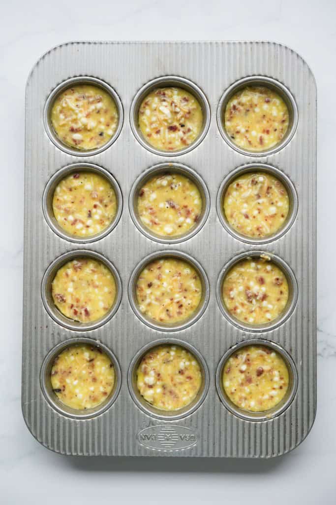 Unbaked egg bites in muffin tin