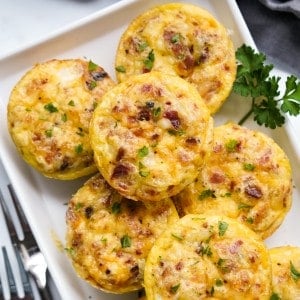 Close up of a bacon egg bites stacked together on a plate