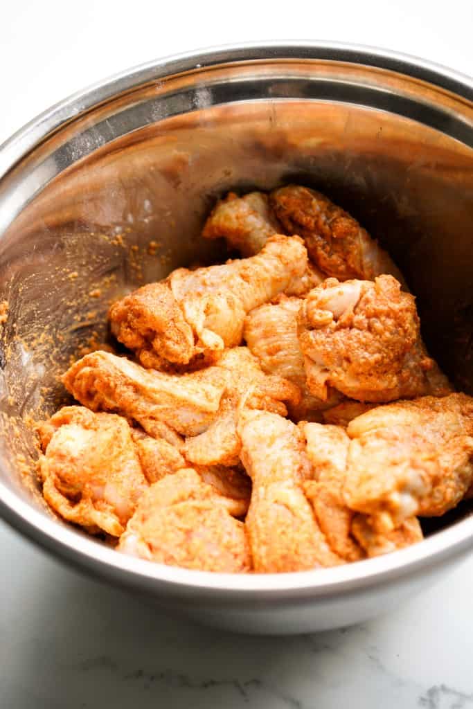Raw chicken wings tossed in dry rub