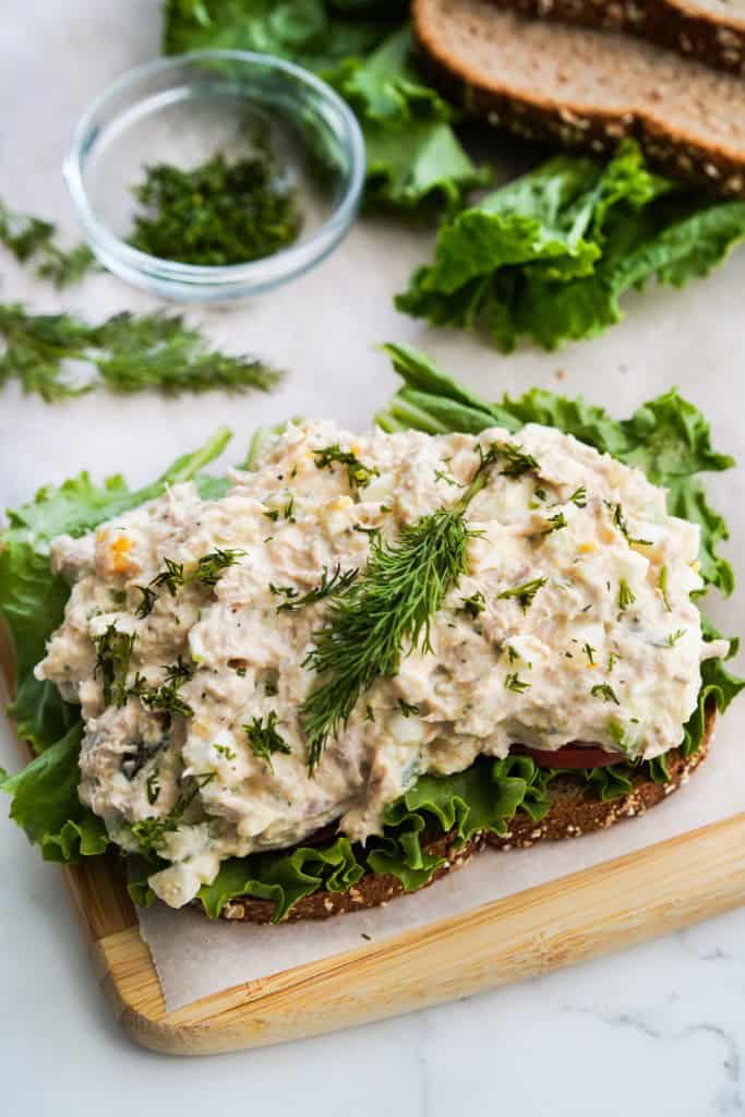 A heap of Egg Tuna salad on top of a sandwich bread 