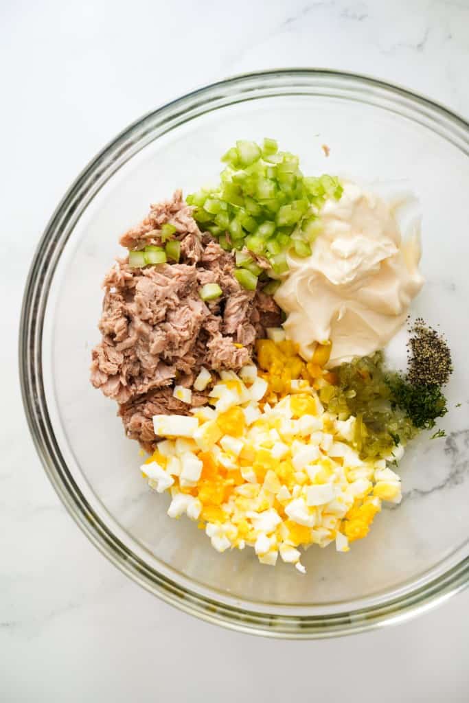 Canned tuna, diced celery, chopped boiled eggs., mayo, mustard, pickled relish in a large mixing bowl