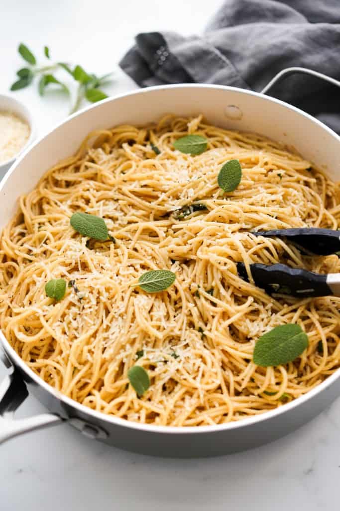 A large pot of spaghetti tossed in brown butter, sage and garlic.
