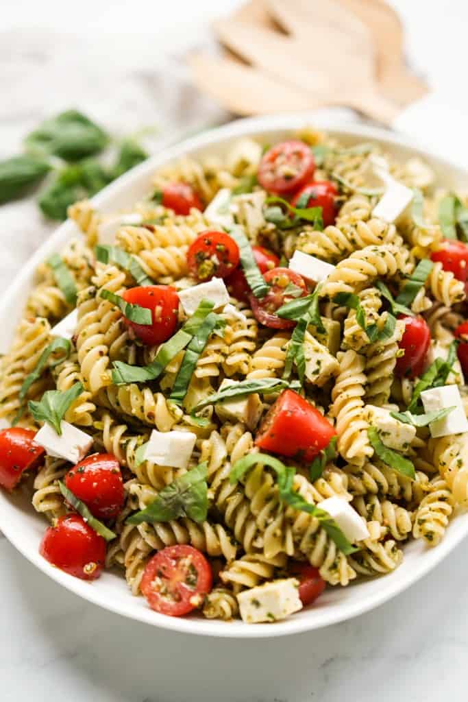 Pesto pasta salad tossed in pesto mayo sauce