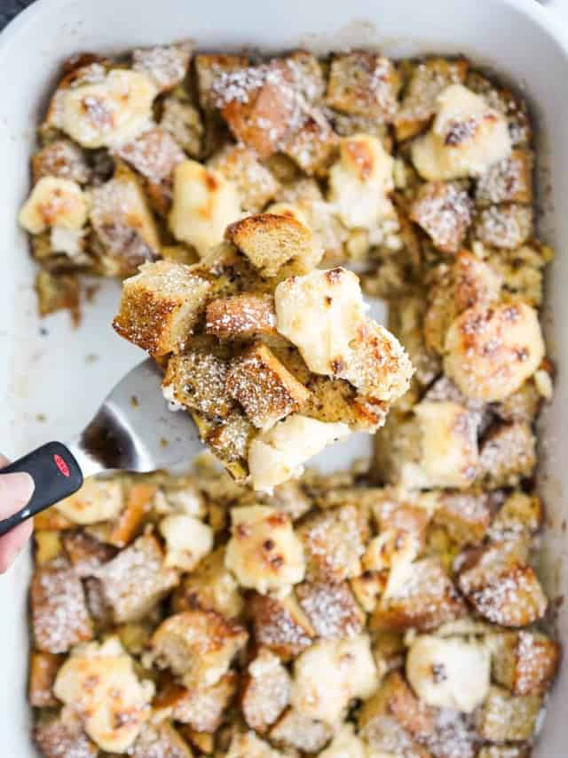 French toast baked in a casserole dish topped with drops of cream cheese