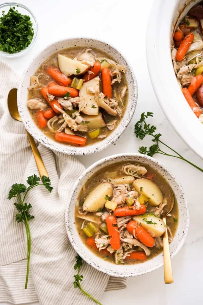 Top down view of two bowls of crockpot chicken stew