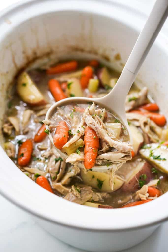 Scooping up chicken stew from the slow cooker