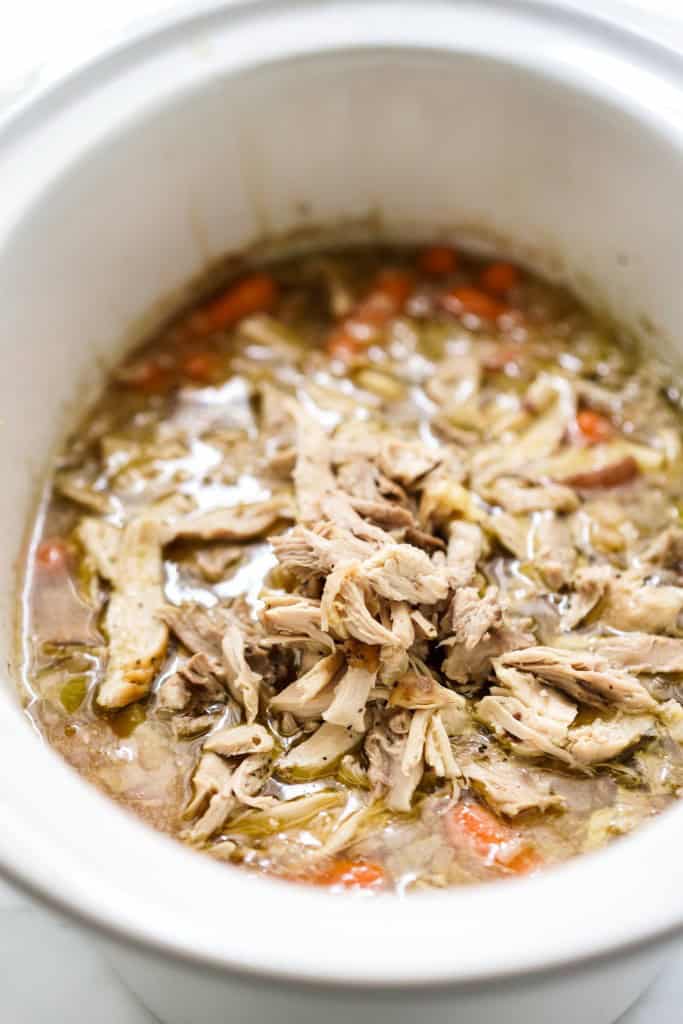 Chicken Stew in slow cooker topped with shredded chicken