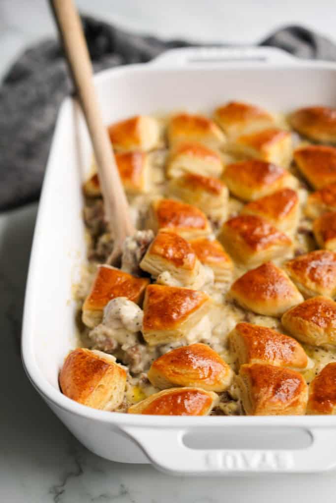Grabbing a spoonful of biscuits with thick chunky sausage gravy