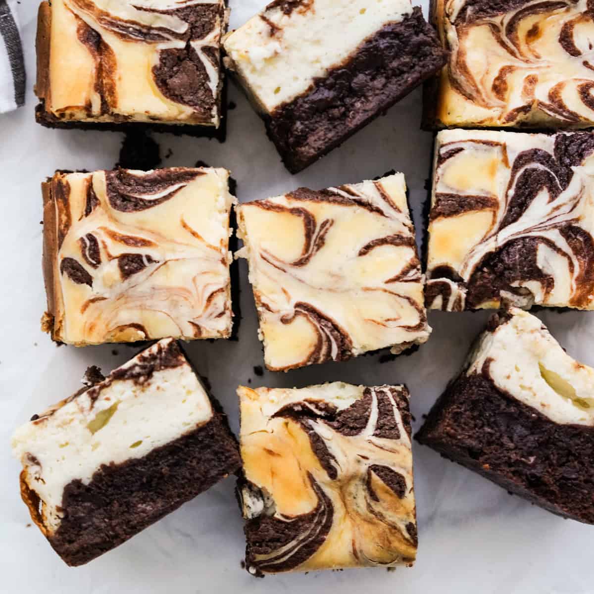 Square slices of cheesecake brownies with a marble swirl