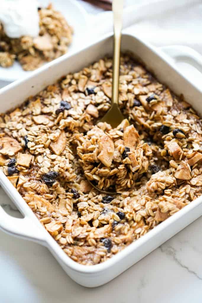Scooping up a large spoonful of baked apple oatmeal