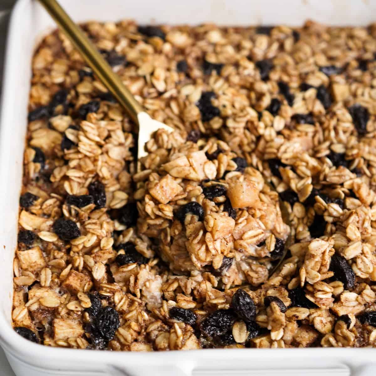 Picking up a casserole of Baked Apple Oatmeal with a large spoon