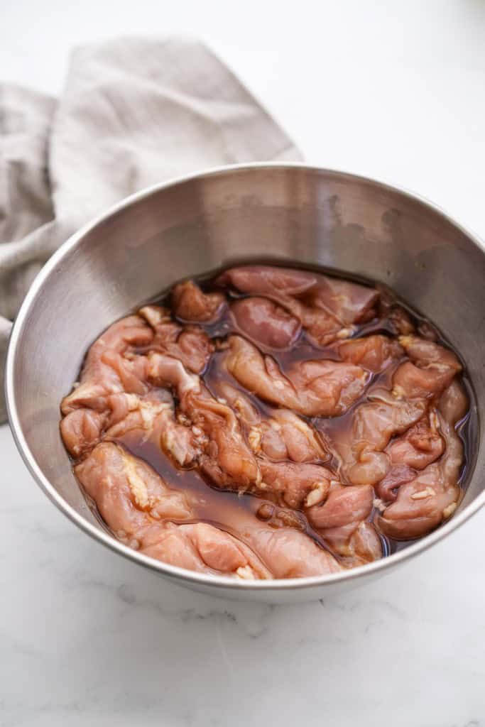 Chicken in teriyaki marinade in a bowl