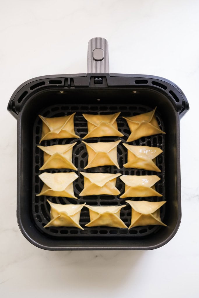 Crab rangoon pieces in the airfryer preior to cooking