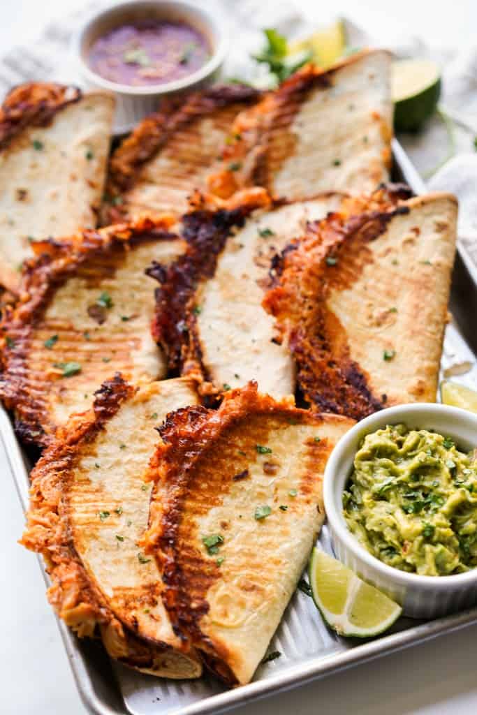 Crispy rotiserrie chicken tacos on a baking sheet
