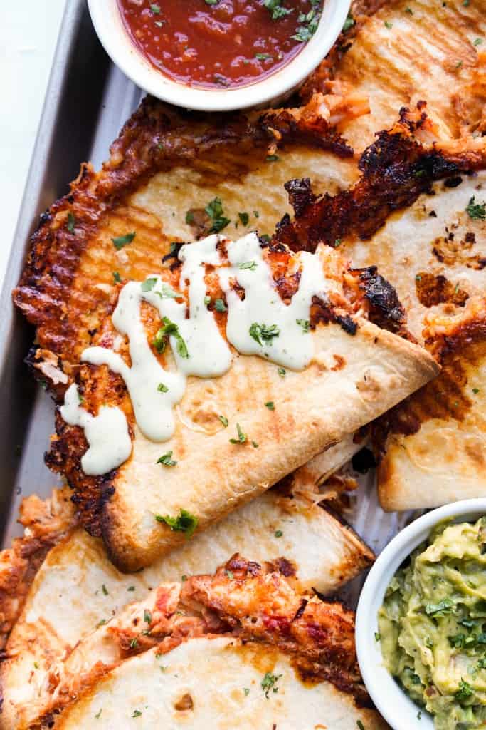 Crispy baked chicken tacos drizzled with cilantro lime dressing