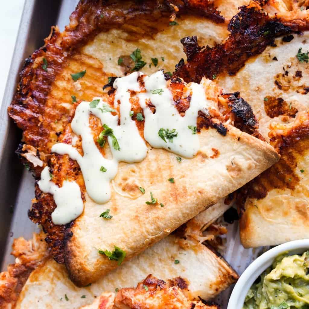 Baked chicken tacos topped with creama
