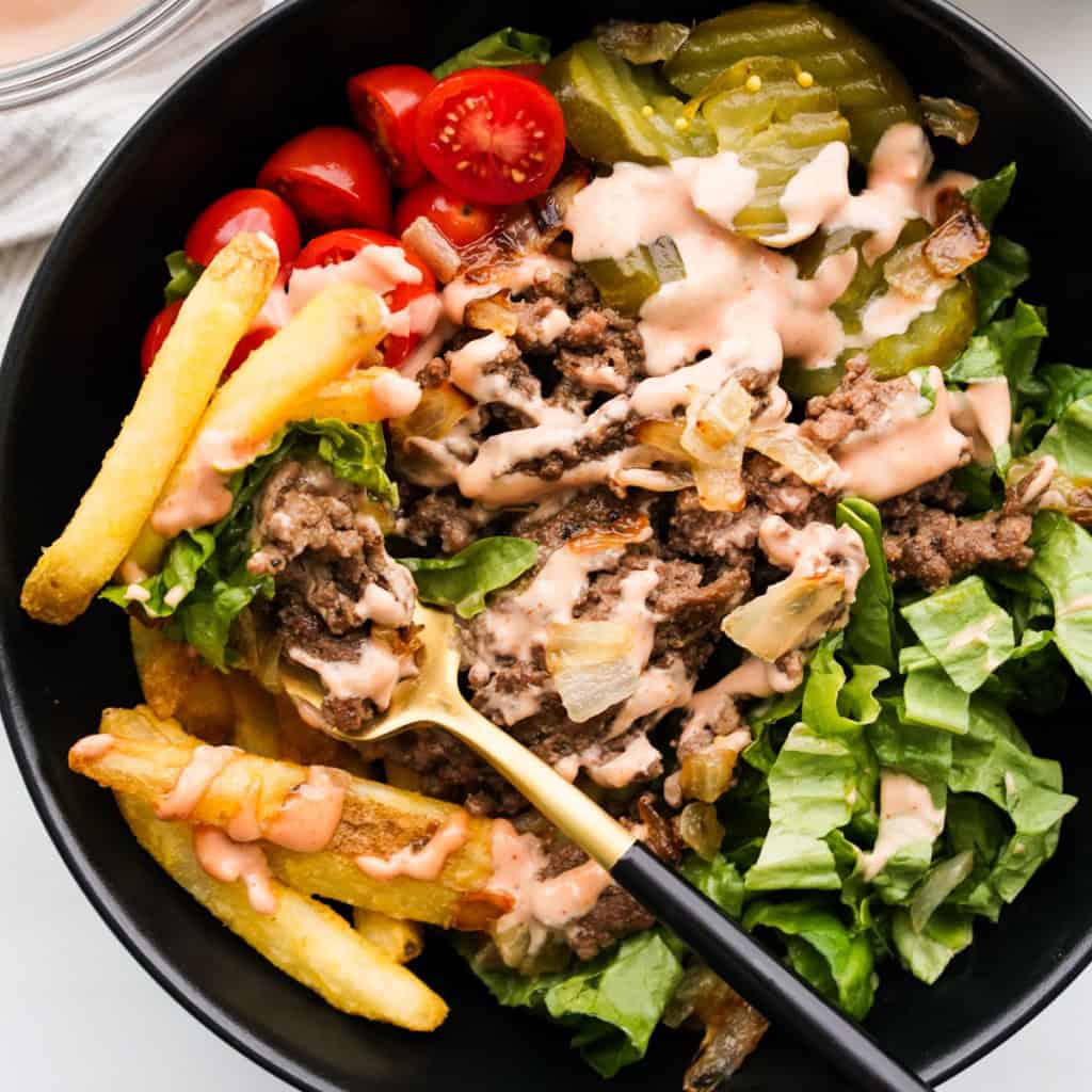 Fork digging into a burger bowl