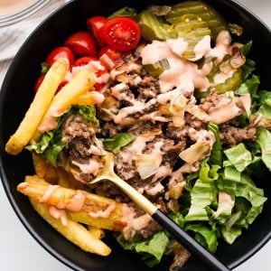 Fork digging into a burger bowl