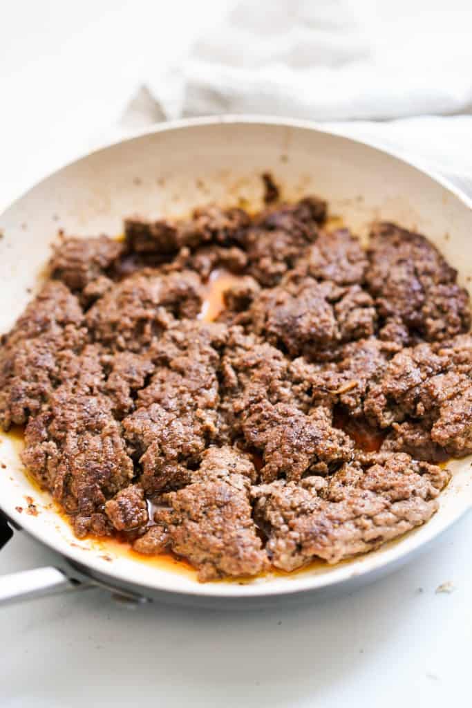 Cooked ground beef patty meat on a skillet