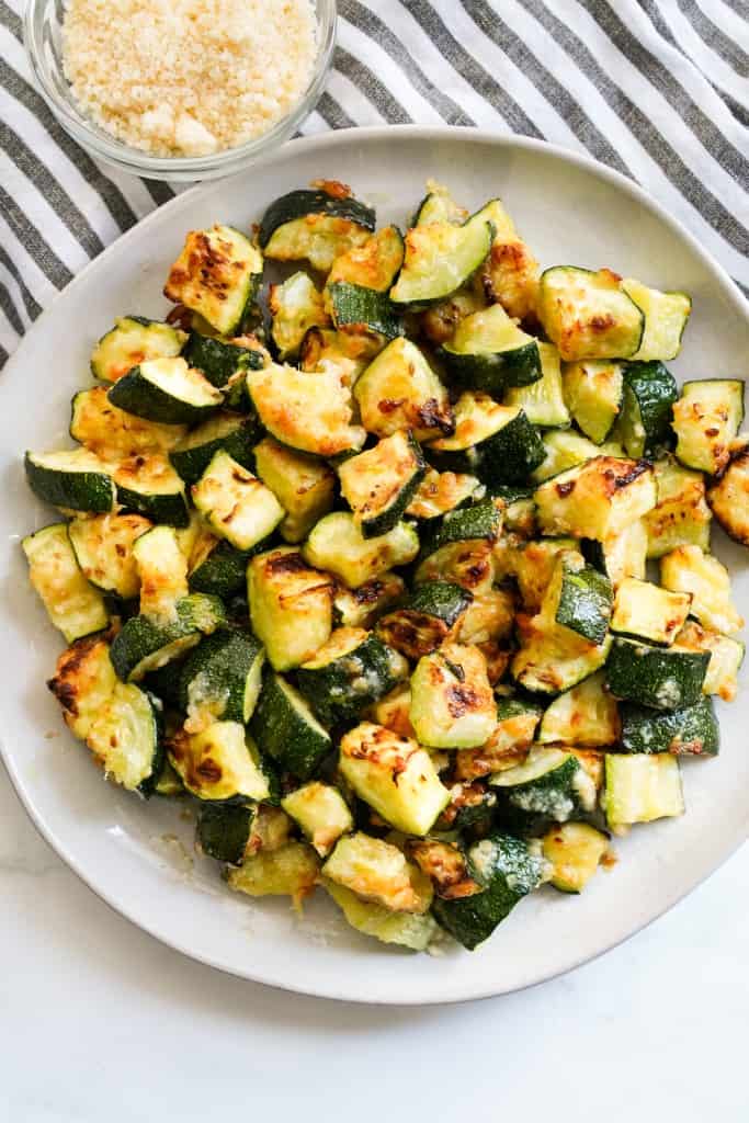 Air fryer zucchini with a crispy parmesan crust on a plate